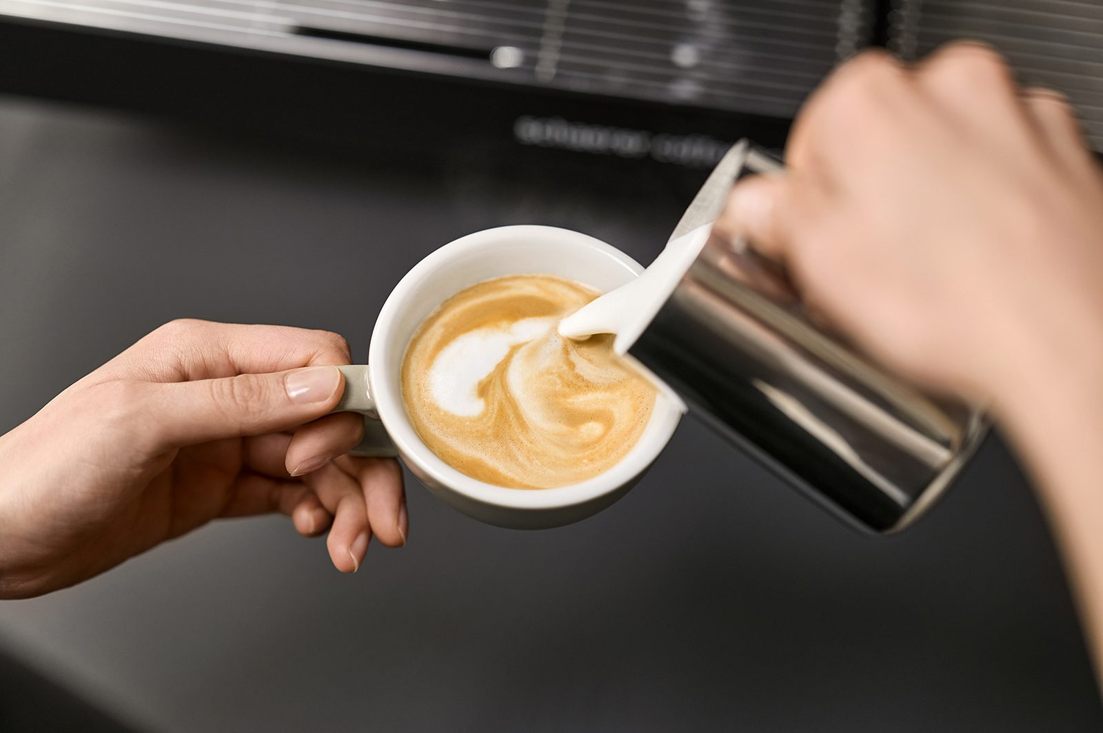 Barista pouring latte art